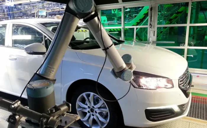 A car being inspected with the GapFlex robotic system integrated in the production line